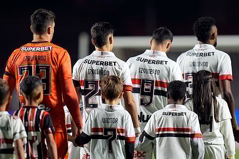 Juan Izquierdo: Players of Brazil's Sao Paulo enter the field wearing jerseys with the name of the late Uruguayan soccer player